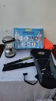 AVEE PPE Kit blue packaging with icons of protective gear shown, plus CamelBak hydration pack and other items on table