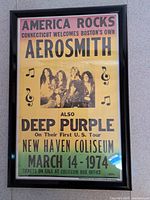 Framed Aerosmith and Deep Purple reproduction poster in black plastic frame with glass front. Measures approximately 12x17.5 inches.