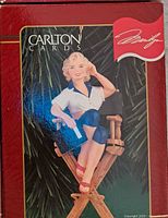 Marilyn Monroe ornament box showing figure seated on director's chair, white and blue outfit