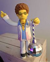 Close-up of Disco Stu figure holding disco ball accessory