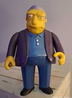 Close-up of Fat Tony figure showing details of facial expression, clothing, and paint condition.