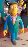 Close-up image of Principal Skinner figure featuring detailed facial features, clothing colors, and articulation points.