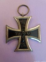 Close-up image of the Iron Cross WW1 medal with black enamel and silver edges dated 1914.