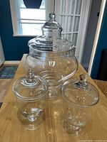 Photo of all three apothecary jars on a wooden surface showing relative sizes and shapes.