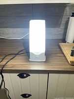 Front view of Verilux Happy Light 6000 powered on at high brightness on countertop.