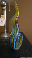 Close-up photo of the multicolored art glass sculpture with swirl design.