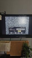 31 inch Toshiba television powered on, screen showing noise reduction settings with static background.