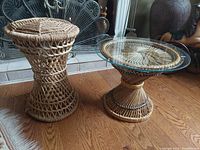 Photo of rattan stool and glass topped rattan table on wood floor with decorative fireplace in background