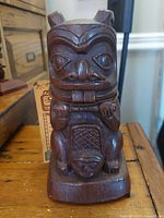 Front view of the carved wooden beaver figure showing detailed facial and body features.
