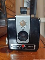 Front view of Kodak Brownie Hawkeye camera showing lens, viewfinder and model nameplate.