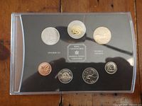 Set of seven Canadian coins displayed in transparent plastic holder with black background, centered by Royal Canadian Mint logo