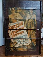 Front view of a vintage 1946 'Tarzan and the Leopard Woman' movie ad printed on rustic horizontal wooden slats, showing the full colorful artwork with key cast names and imagery.