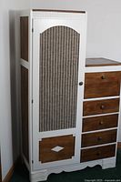 Front left-side view of wardrobe showing woven panel door, drawers, and wood and white color scheme