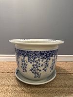 Porcelain planter showing exterior floral vine decoration and wide flared rim