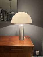 Front view of lamp illuminated on wooden surface showing overall form