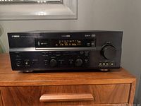 Front view of the Yamaha RX-V559 AV Receiver showing buttons and headphones jack.