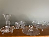 Five clear glassware items including a mini cream and sugar set, fan vase, handled tray, round three-footed bowl, and a three-section footed plate all featuring Imperial 'candlewick' bubble style rim accents.