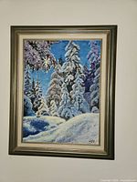 Wall painting showing a snowy forest with star feature, framed in silver-toned wood.