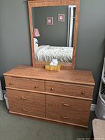 Wood finish dresser with matching framed mirror, drawers with wooden and metal handles