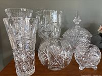 Group photo of 6 hand cut Barski 12-point star pinwheel lead crystal pieces including various vases and bowls with intricate star pinwheel patterns