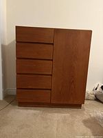 Front view of teak dresser showing five drawers left and solid door right