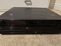 Front view of black Sony unit showing 5-disc CD mechanism and controls