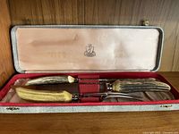 Stag horn meat carving set in original lined box with emblem on lid interior