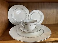 Arrangement showing dinner plate, salad plate, bread & butter plate, footed cup and saucer with silver Chantilly pattern.