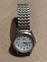 Acqua Indiglo wristwatch with silver and gold-tone metal linked bracelet, white dial, black numbers