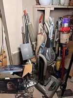 Assortment of vacuum cleaners in corner against wall