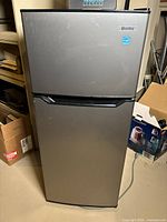 Front view of Danby refrigerator with stainless steel finish, showing two doors and Danby logo.