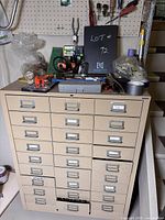 Front view of beige metal tool cabinet with tools on top