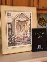 Full view of framed print leaning against cupboards showing the entire artwork and frame.