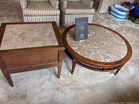 Coffee and end tables side by side showing marble tops and wood frames with mid-century modern styling and wear.