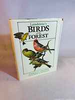 Front cover of the book showing detailed colored bird illustrations and the book title.