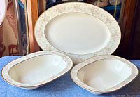 Set of Noritake Willowbrook fine bone china platter and two serving bowls on blue surface.