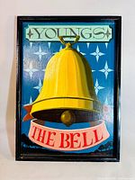 Front view of the vintage pub sign showing the yellow bell, 'YOUNGS' text, and 'THE BELL' banner