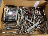 Box with assortment of wrenches, sockets, ratchets and locking pliers