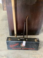 Overview of all four items: Milwaukee Super Sawzall metal case, MintCraft Pro sledgehammer, two crowbars; arranged against wooden backdrop