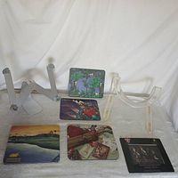 Full view including metal adjustable computer/tablet stand, clear plastic stand, and six assorted coasters with printed designs.