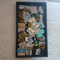 Top view of assorted earrings in display tray showing variety of shapes, sizes, colors and packaging.