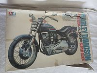 Box of Tamiya Harley Davidson FE1200 Superglide model kit showing damaged condition and illustrated artwork.
