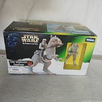 Front view of the original packaging showing Luke Skywalker riding the Tauntaun with a separate window displaying the figure.