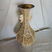 Full side view showing corpoate floral and decorative carvings and handles on both sides.