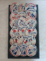 Tray containing 18 round pin back buttons with vintage political and social slogans mainly in red, white, and blue