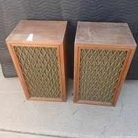 Pair of vintage Pioneer CS-88A speakers shown side by side with wooden lattice grills over green fabric.
