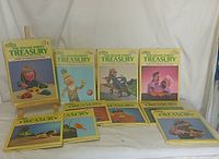 Front view of 10 Sesame Street Treasury books arranged in two rows on a table, showing colorful covers and yellow spines with Sesame Street muppets.