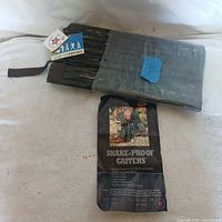 Pair of snake proof gaiters folded with original tag showing product branding and features.