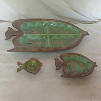 Top view of all three Treasure Craft of Hawaii ceramic pieces showing the leaf motif and green glazed interiors.