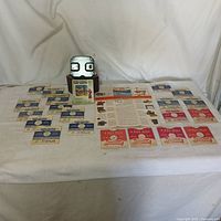 Full set displayed on white cloth backdrop: View-Master viewer, 20 reels, instruction booklet, promotional materials spread out.